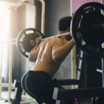 Strength Training Wherever and Whenever A Shirtless Man Doing A Barbell Squat For Strength Training