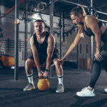 Workout Routine Man Swinging A Yellow Kettlebell